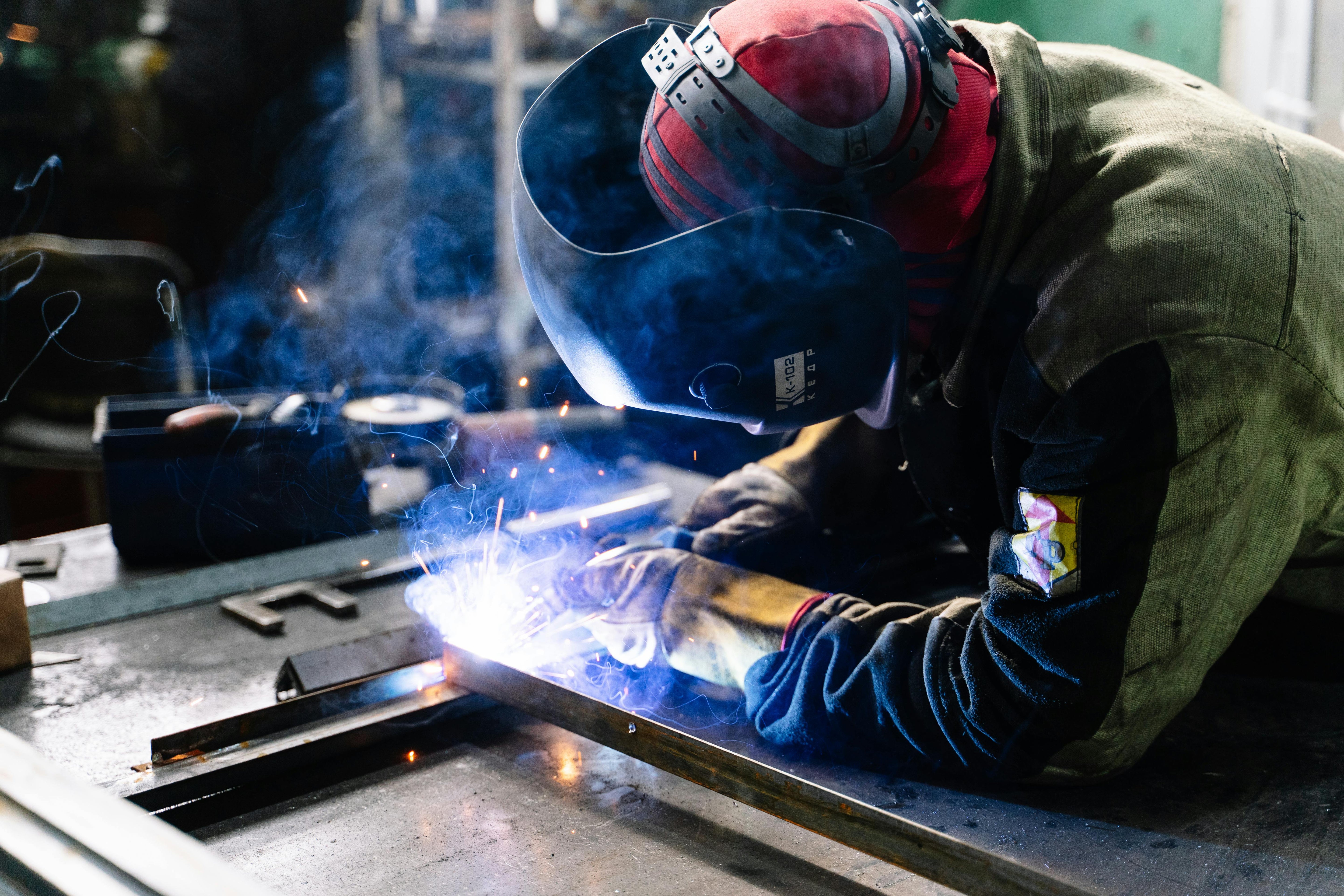 A Person Welding on a welding bench