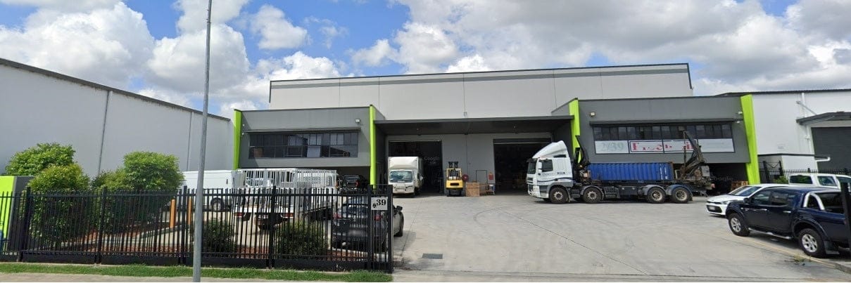 ProcureIT & Industrial Source Warehouse, Featuring Trucks Being Unloaded and shipping containers.