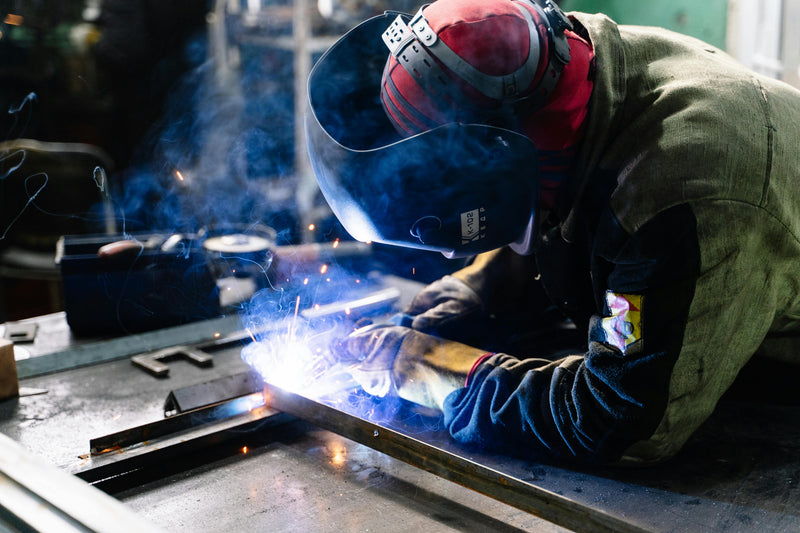 A Person Welding on a welding bench